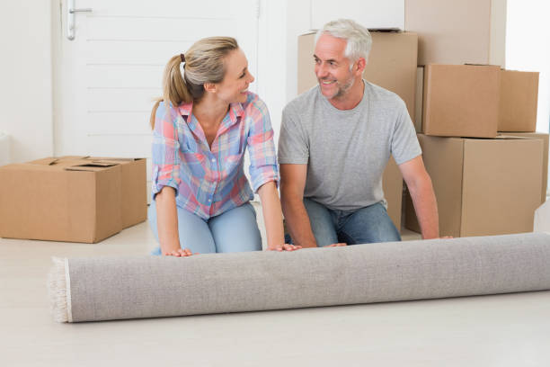 istock Happy couple rolling out new rug 692751006