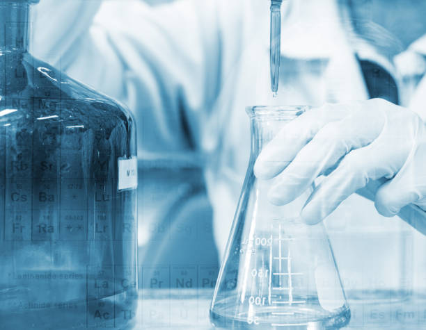 istock Scientist hand titration with burette and erlenmeyer flask, science laboratory research and development concept 692756098