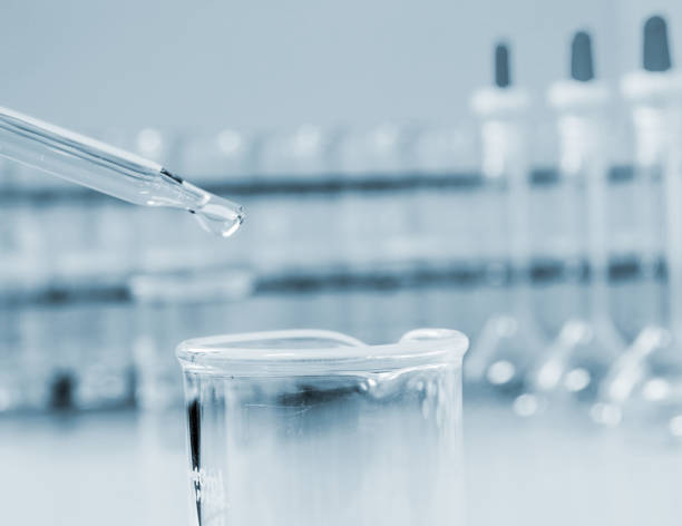 istock Laboratory closeup of droper with Beaker on science glassware background . 692758490