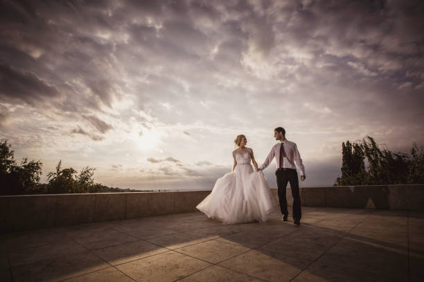 istock Happy married couple taking a walk on a rooftop and communicating. 692762578