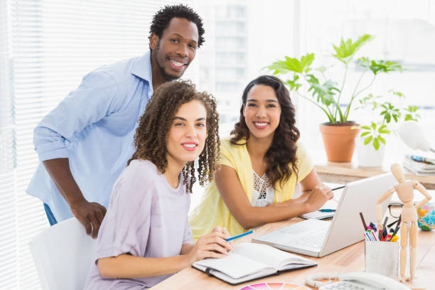 istock Portrait of smiling colleagues looking at camera 692764818