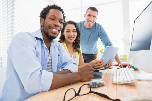 istock Portrait of smiling colleagues looking at camera 692767698