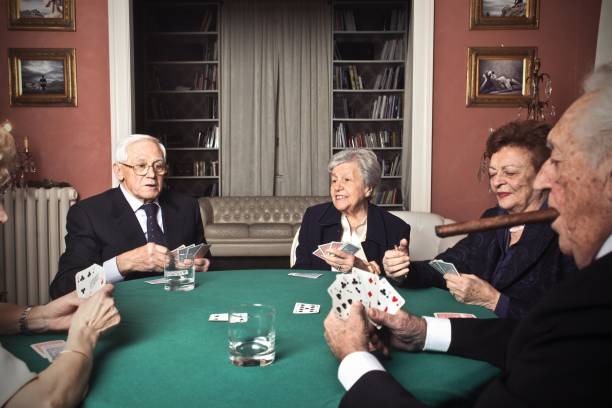 Poker party Elderly people are playing poker smoking women luxury cigar stock pictures, royalty-free photos & images