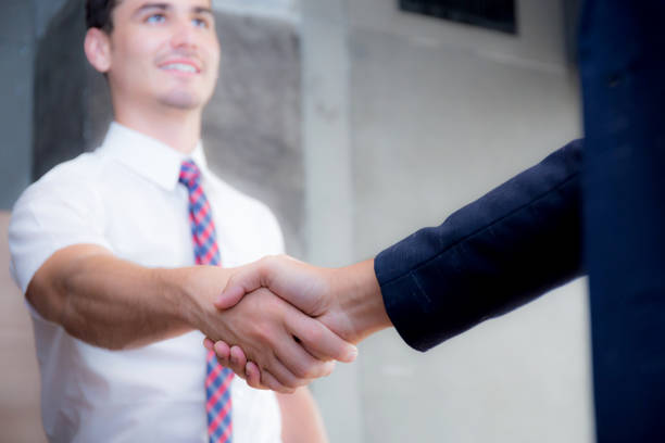 istock Two happy successful business partner shaking hands in the office. 692768342