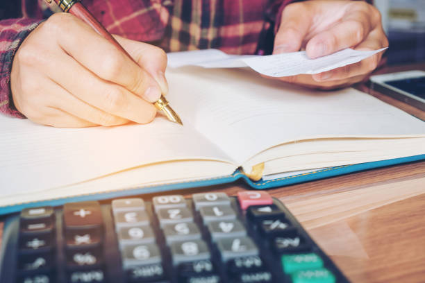 istock Businessman's hands with calculator counting making notes at home 692768782