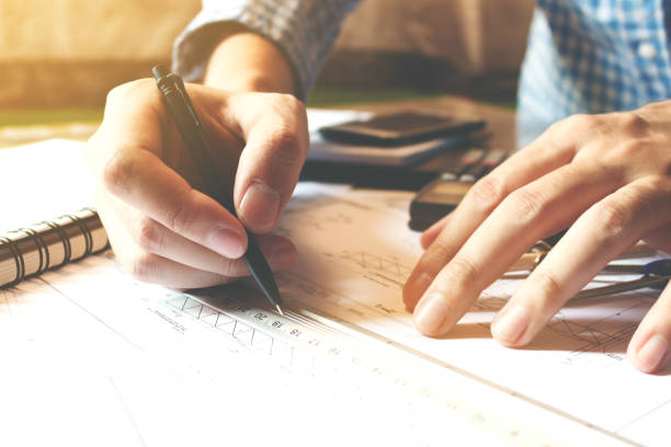 istock Architect man working with drawing compass on desk office room. 692769264