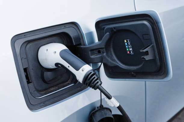 istock Electric car being charged, side view 692772542