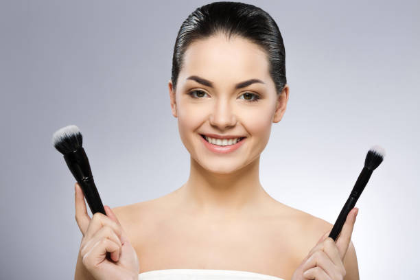 istock Cute girl holding make up brushes 692772824