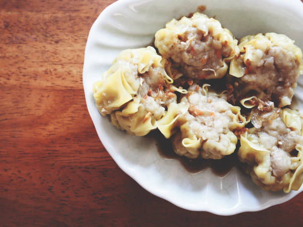 istock This is pork Chinese steamed dumpling in white plate above wooden table, soft tone 692775304