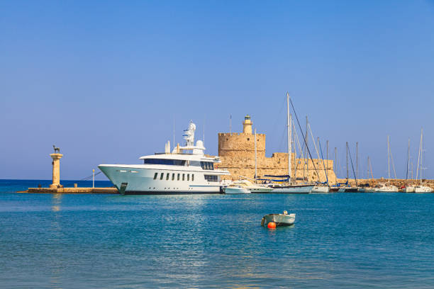 Mandraki harbour entrance Rhodian deer atop the columns on the Greek island of Rhodes, Greece