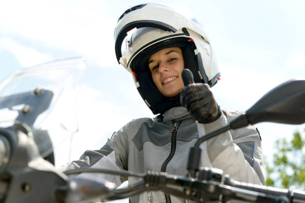 istock girl sits on a motorcycle and has a helmet on his head 692783496