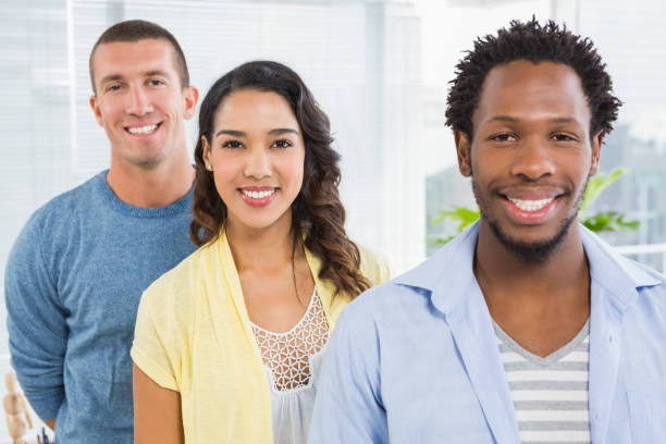 istock Portrait of smiling colleagues looking at camera 692784604