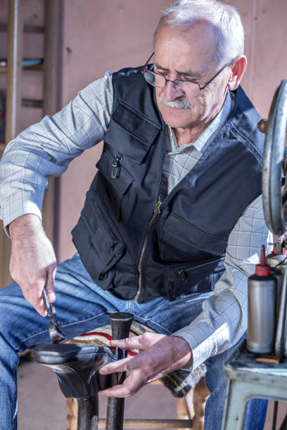 istock Senior Man making shoes at a factory 692787276