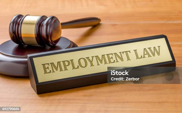 A Gavel And A Name Plate With The Engraving Employment Law Stock Photo - Download Image Now