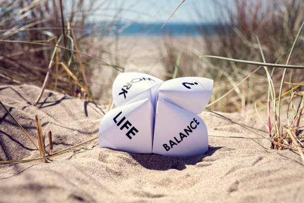 Work life balance choices Origami fortune teller on vacation at the beach concept for work life balance choices life balance photos stock pictures, royalty-free photos & images