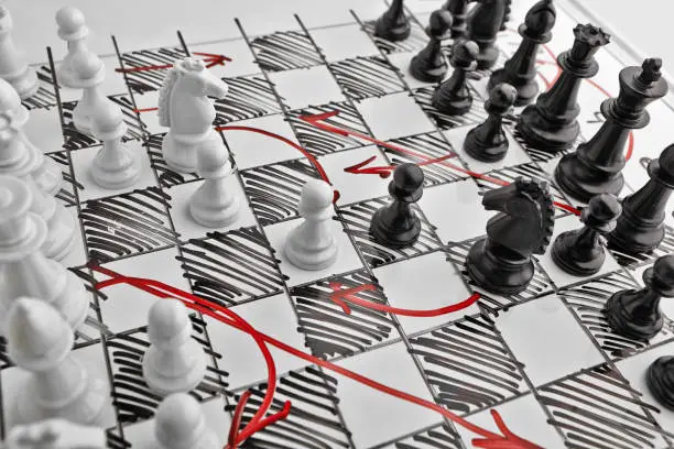 Chess. White board with chess figures on it. Plan of battle.