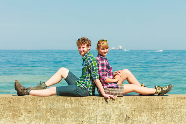 istock hiking couple relaxing on sea coast 692804830