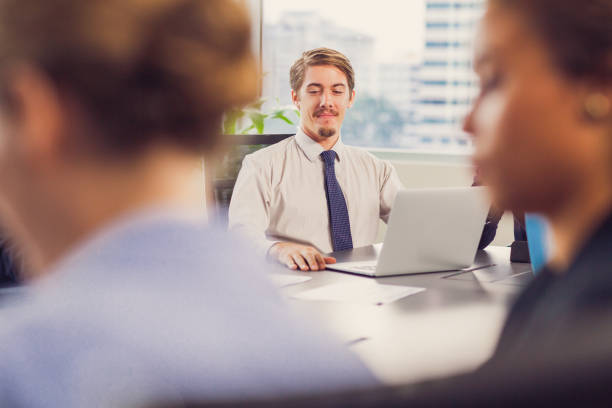 istock Businessman Smiling at Meeting in Office 692806190