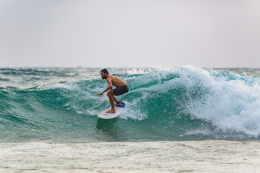 Surfer at Narigama beach in Hikkaduwa. Hikkaduwa, situated 98 km south of Colombo, has been a favourite destination with international surfers for three decades. Because it also attracts non-surfers, this fishing village has a comprehensive and well-developed tourist infrastructure