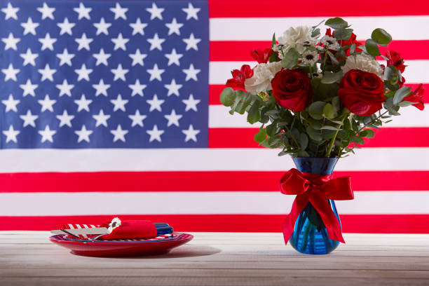istock Beautiful bouquet and table setting in front of american flag 692811644
