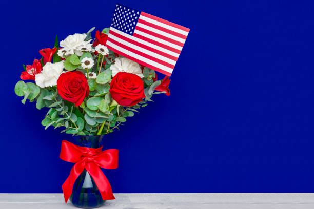 istock Beautiful bouquet with american flag on blue background 692811990