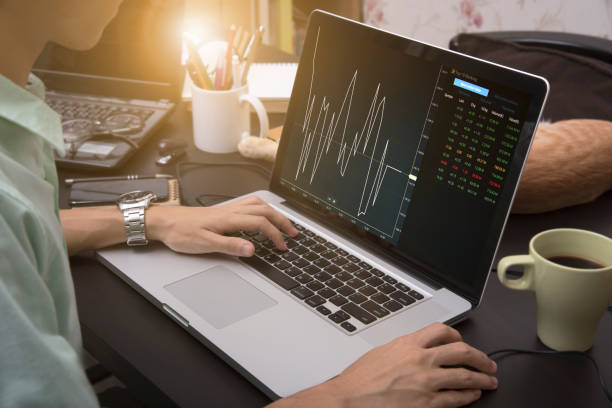 istock business hand working on computer notebook with Finance Trading Stock Graph Chart homepage on computer screen. invesment analysis concept. 692812520