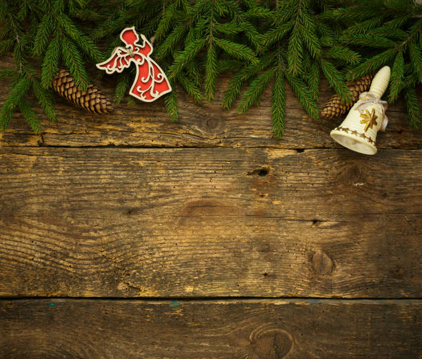 istock Christmas tree branches with cones and christmas decorations on wooden texture ready for your design 692813120