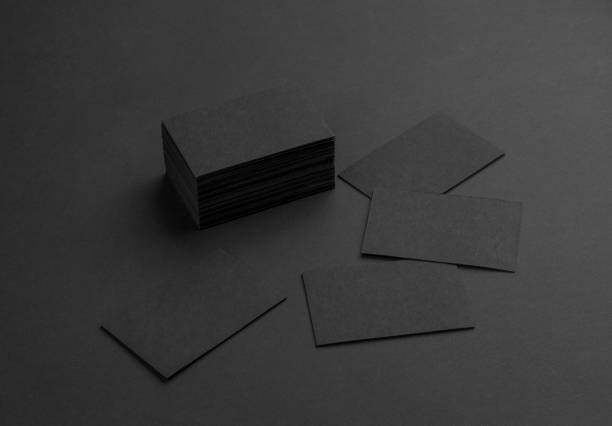 istock Black business cards isolated on black background 692813816