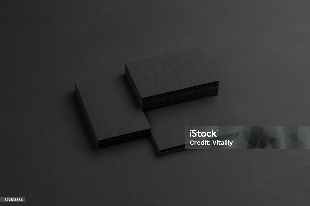 Black business cards isolated on black background Photo of black business cards. Dark template isolated on black background. For graphic designers presentations and portfolios. Business card mock-up black ob black. Business Card Stock Photo