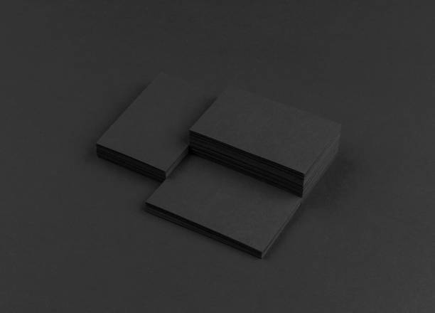 istock Black business cards isolated on black background 692813842