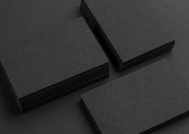 istock Black business cards isolated on black background 692813954