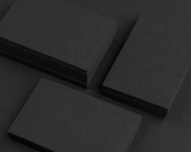 istock Black business cards isolated on black background 692813970
