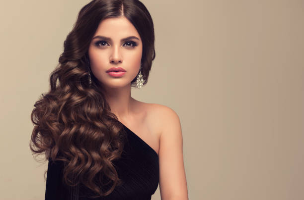 istock Young attractive brunette with voluminous, shiny and curly hairstyle. 692814138