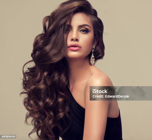 Young Attractive Brunette With Voluminous Shiny And Curly Hairstyle Stock Photo - Download Image Now