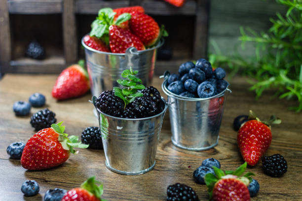istock Mix Berries strawberries, blueberries, blackberries on Wooden Background. Summer Organic Berry over Wood. Agriculture, Gardening 692818708