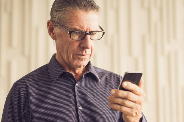 istock Worried Senior Man Reading Text Message on Phone 692818926