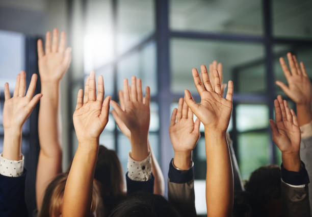 We stand together Cropped shot of a group of unrecognisable businesspeople with their hands raised hand raised stock pictures, royalty-free photos & images