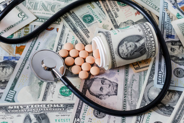 istock Medicine pills or capsules with dollars concept. 692832782