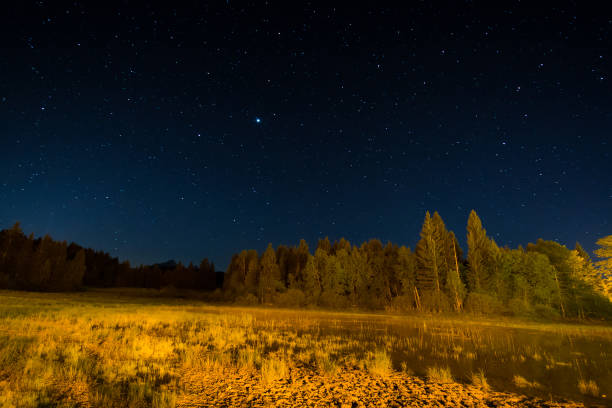 istock Moor and lake at night under starlight 692833122