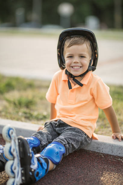 istock Child taking a break from riding in-line skates. 692834890