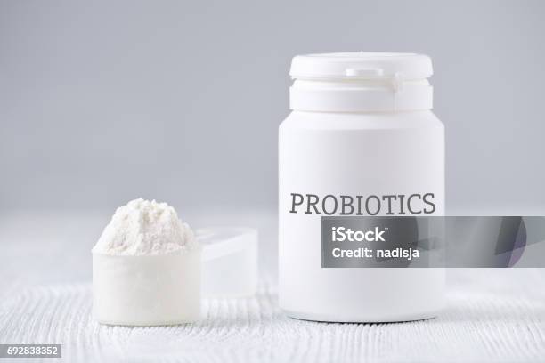 A Jar And Spoon With Probiotic Powder On Gray Stock Photo - Download Image Now - Probiotic, Ground - Culinary, Bacterium