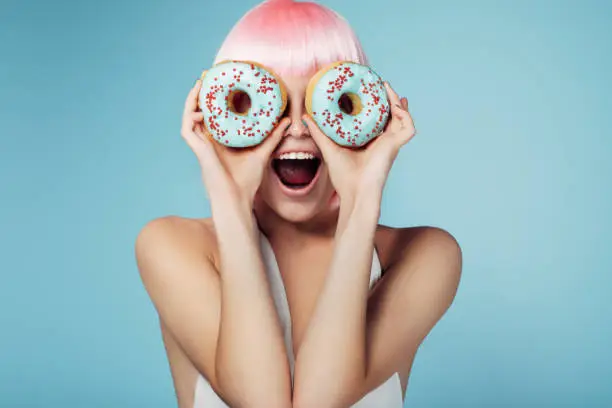 Photo of Pretty blonde with multi-colored donuts