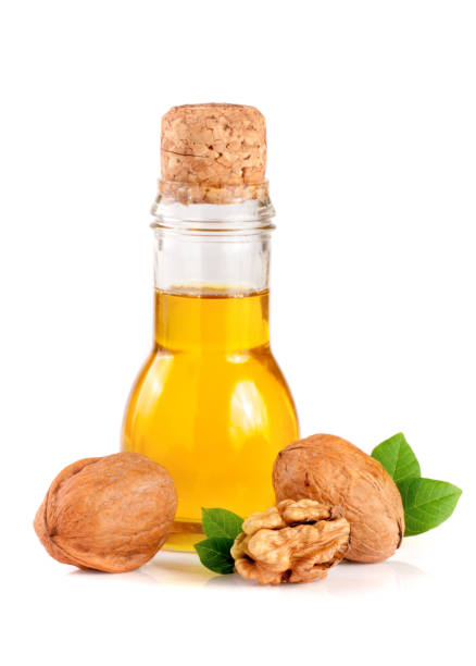 istock Walnut oil with nuts isolated on a white background 692842018