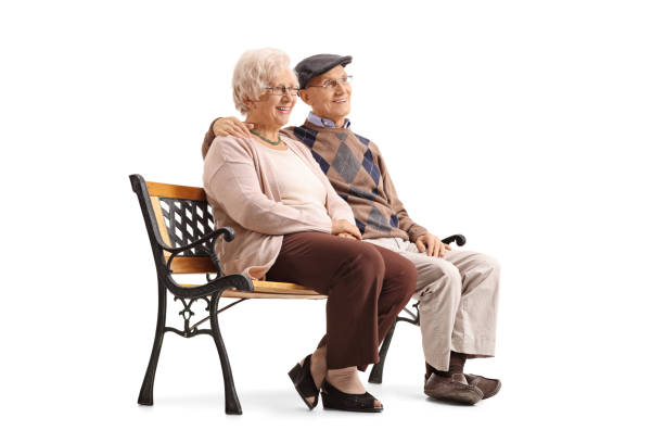 istock Senior couple sitting on a bench and looking away 692848908