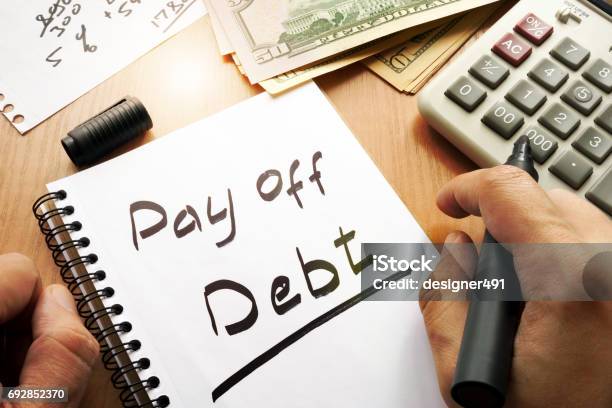 Note With Words Pay Off Debt Concept Stock Photo - Download Image Now - Debt, Bribing, Bank - Financial Building