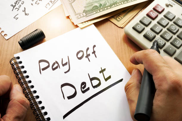 note with words pay off debt concept. - bribing imagens e fotografias de stock