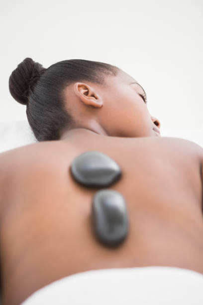 istock Peaceful pretty woman enjoying a hot stone massage 692858410