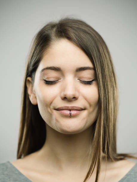 istock Real happy young woman studio portrait with closed eyes 692862894