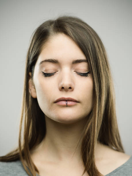 istock Real young woman studio portrait with closed eyes 692863058