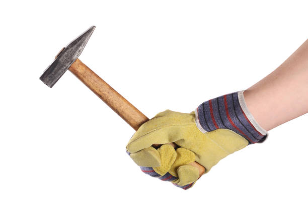 istock Hammer in a man's hand isolated 692872772